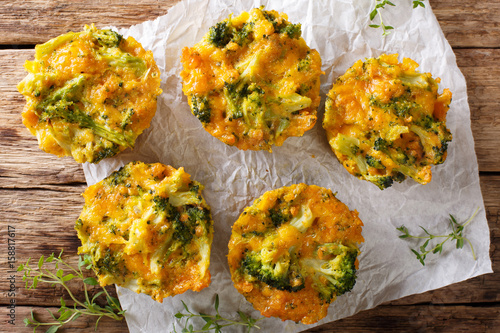 Broccoli bites with cheddar cheese, egg and thyme close-up on the table. Horizontal top view