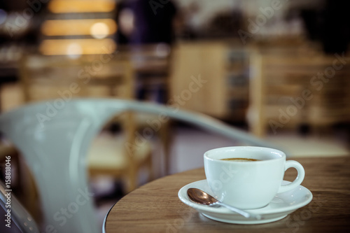 Cup of coffee on table in cafe - vintage style effect picture