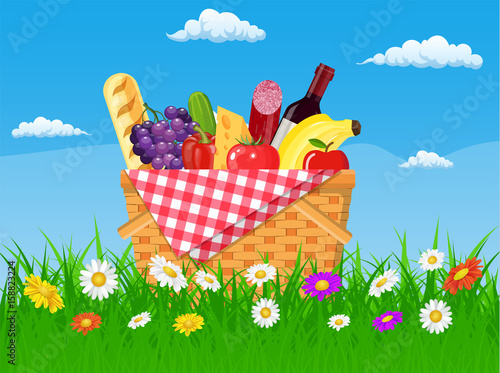 WIcker picnic basket full of products.