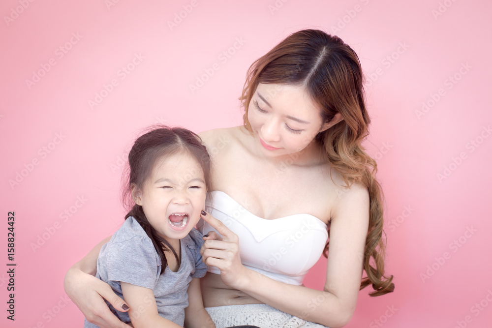woman hodling kid with sad emotion, isolated on pink background. woman hodling kid with sad emotion, isolated on pink background.