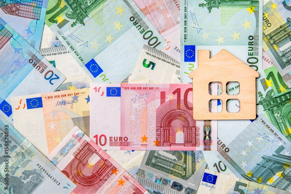 The symbol of the house lies on the background of the Euro The symbol of the house lies on the background of the Euro