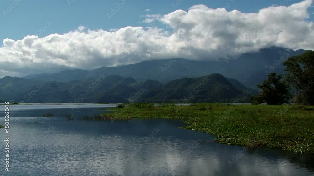 Landscape of beautiful calm Lake Yojoa in Honduras. Mountains on the background Landscape of beautiful calm Lake Yojoa in Honduras. Mountains on the background
