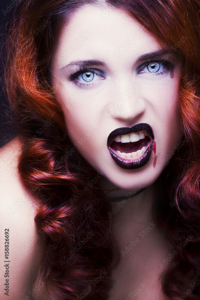 Pretty female fashion model posing in studio with dark gothic make up Pretty female fashion model posing in studio with dark gothic make up