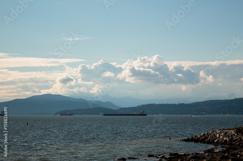 Photo of English Bay view of the blue ocean and mountains, Vancouver, BC