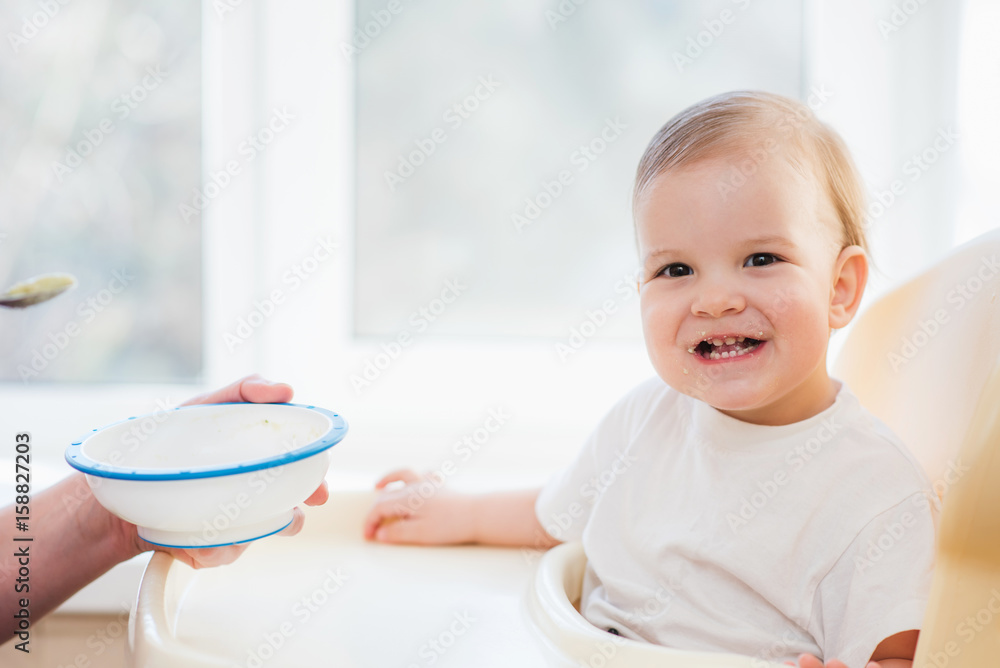 grandmother gives baby food from a spoon grandmother gives baby food from a spoon