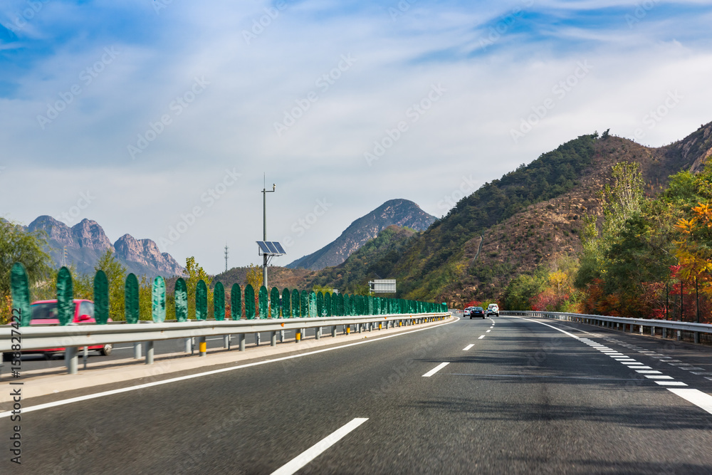 modern highway through mountains against sky,shot in city of China.