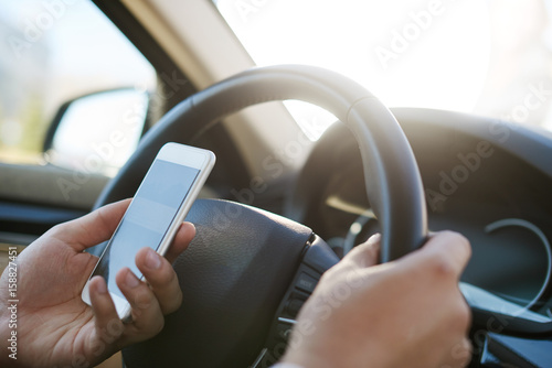 Man texting message in a car