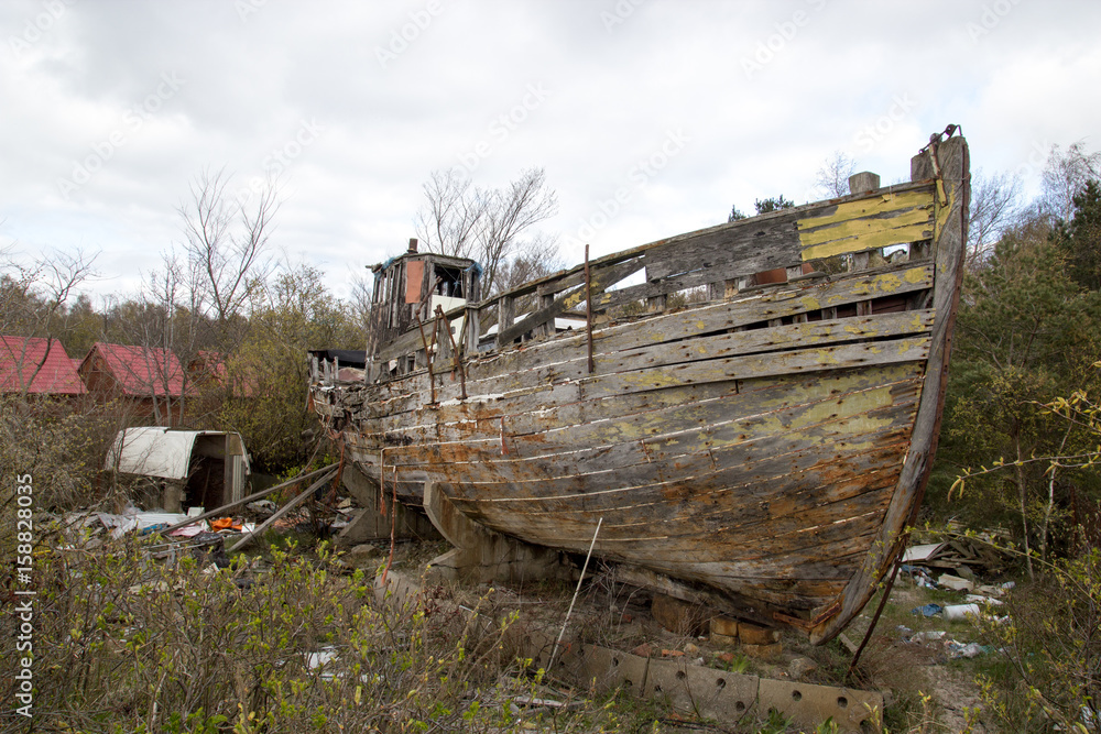 Crumbling wooden boat on the shore