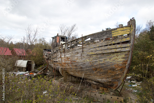 Crumbling wooden boat on the shore