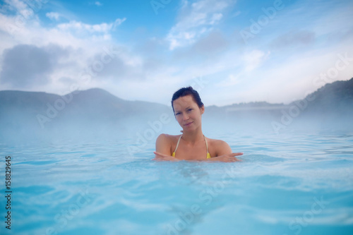 Woman enjoys spa in geothermal hot spring © Nejron Photo