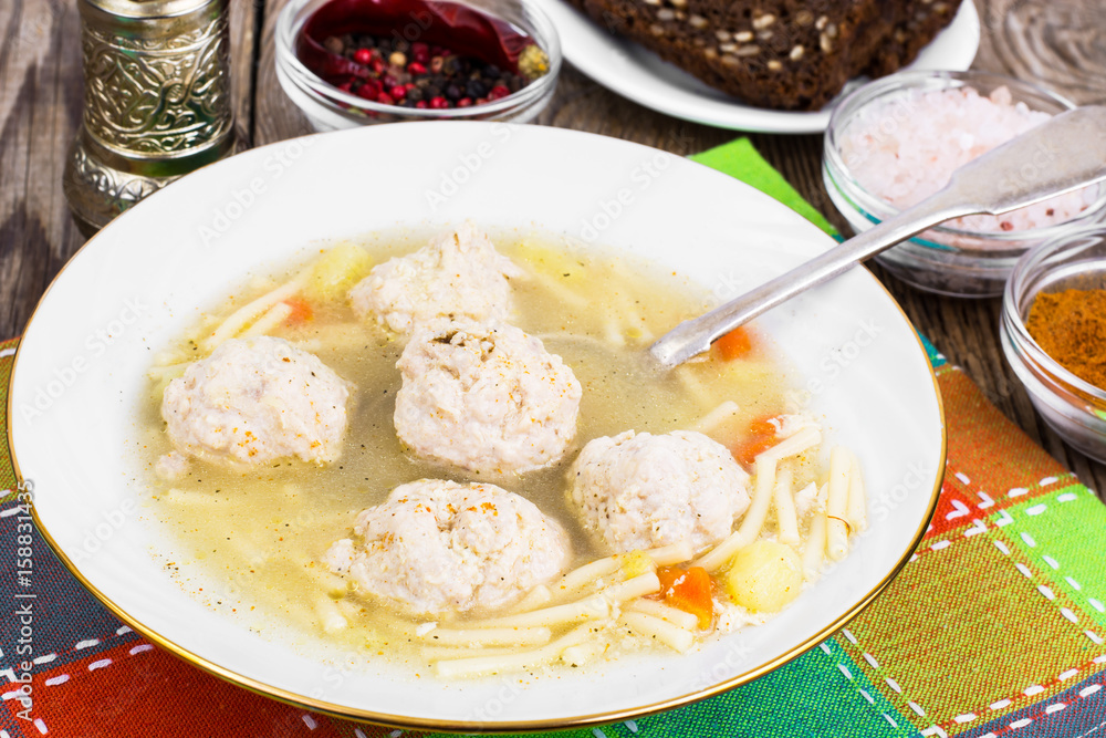 Soup with meatballs in plate