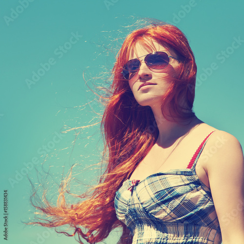 redhead woman in sunglasses © bakharev