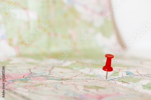 Single red pushpin marking a location on an open map