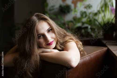  portrait beautiful brunette girl smile in a interior background.