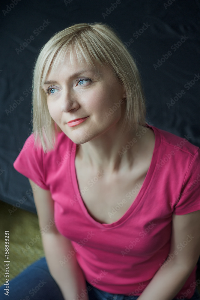 Smiling mature woman wearing fuchsia color shirt vertical portrait Smiling mature woman wearing fuchsia color shirt vertical portrait