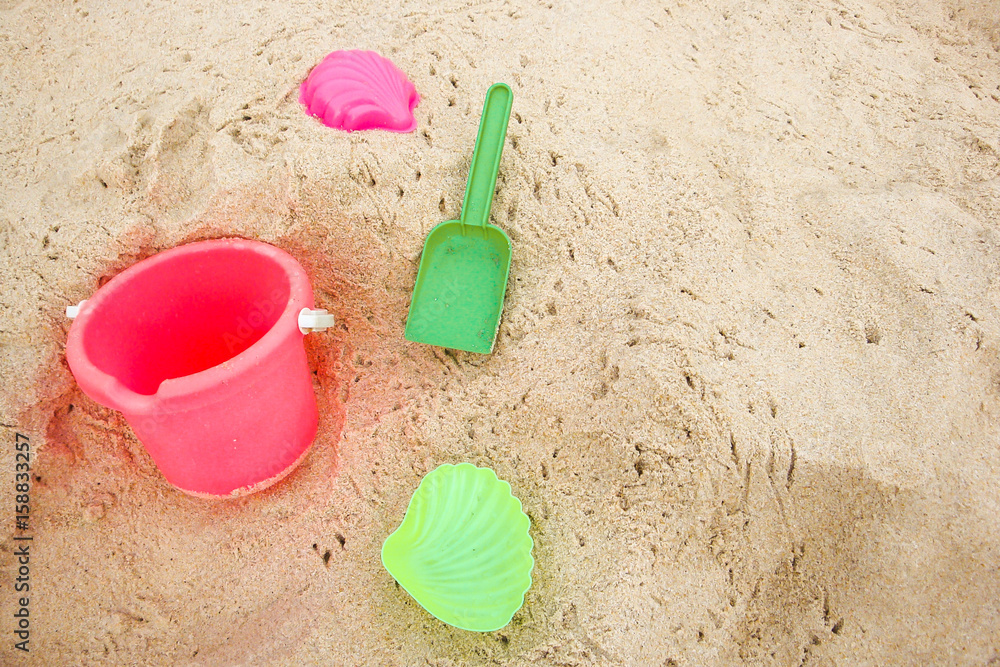 Children's pail and colored molds on the beach in the sand Children's pail and colored molds on the beach in the sand