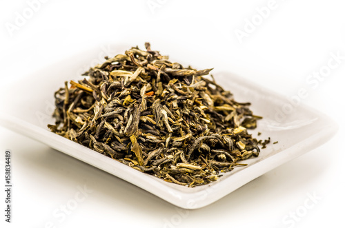 mo li mao green tea leaves on the rectangular plate