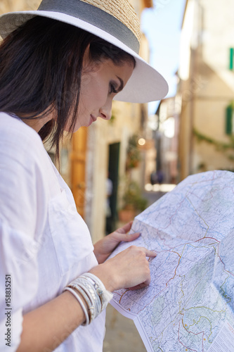Tourist woman with a map in a small Italian town © ZoomTeam