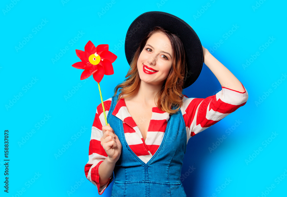 smiling woman with red pinwheel smiling woman with red pinwheel