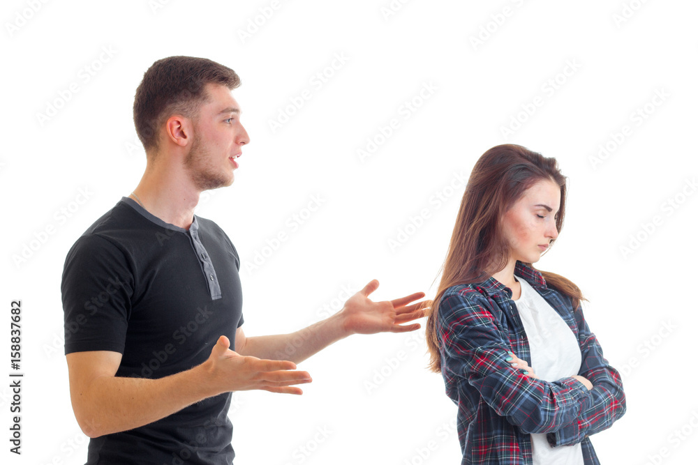 a young man standing near his girlfriend and spreads her hands a young man standing near his girlfriend and spreads her hands