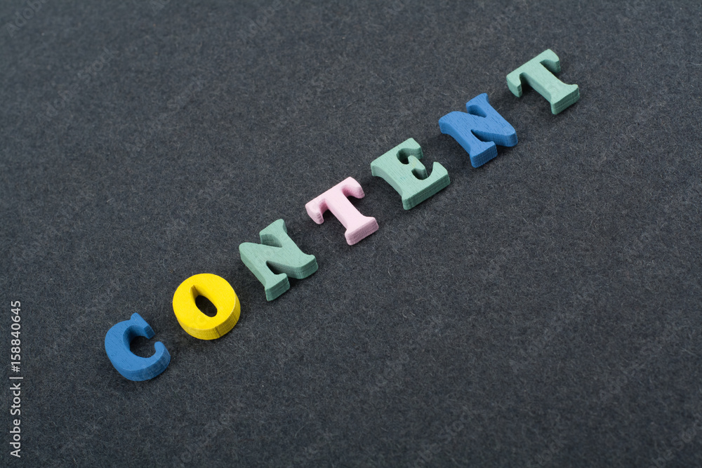 CONTENT word on black board background composed from colorful abc alphabet block wooden letters, copy space for ad text. Learning english concept. CONTENT word on black board background composed from colorful abc alphabet block wooden letters, copy space for ad text. Learning english concept.