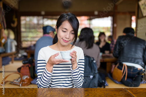 Woman enjoy her tea in japanese restaurant