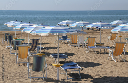 sunshade and sunbeds on the sand of the tourist village © ChiccoDodiFC