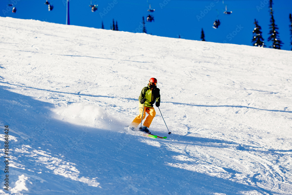 Skier mountain skiing riding on track slope. Concept active rest in winter, photo in motion, snow is scattered. Sheregesh ski resort