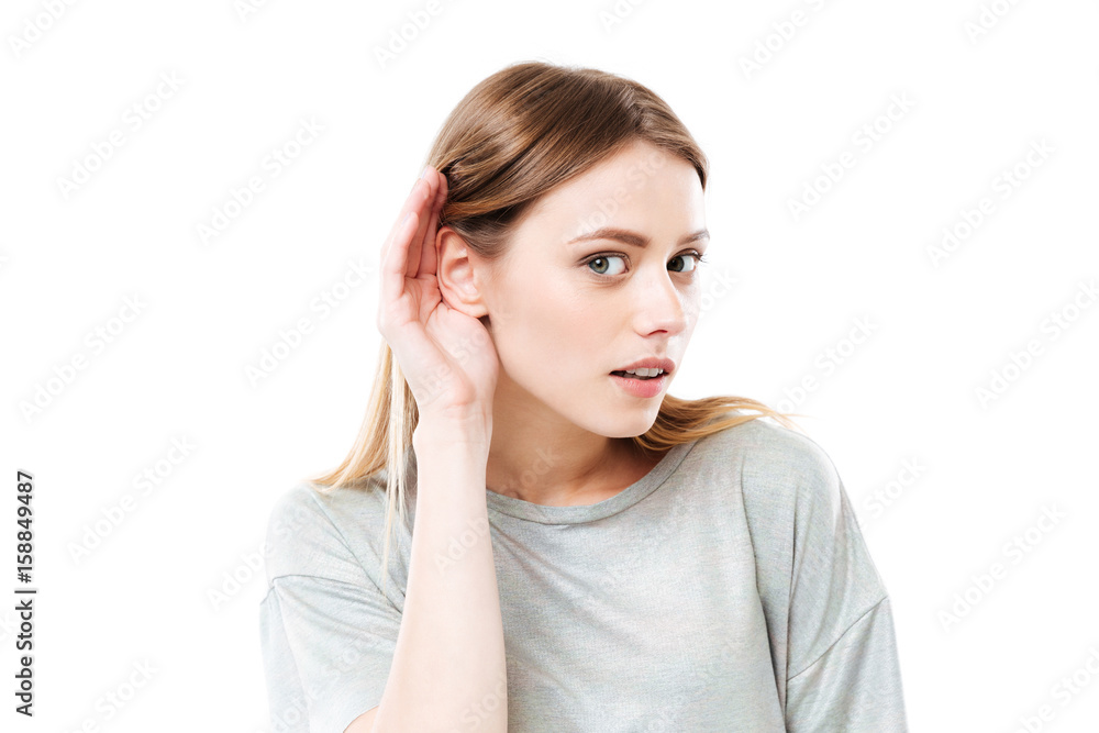 Portrait of a young curious girl trying to hear rumors Portrait of a young curious girl trying to hear rumors