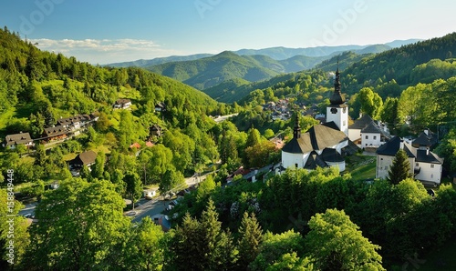 Spring in Slovakia. Old mining village. Historic church in Spania dolina. Springtime colored trees at sunset.