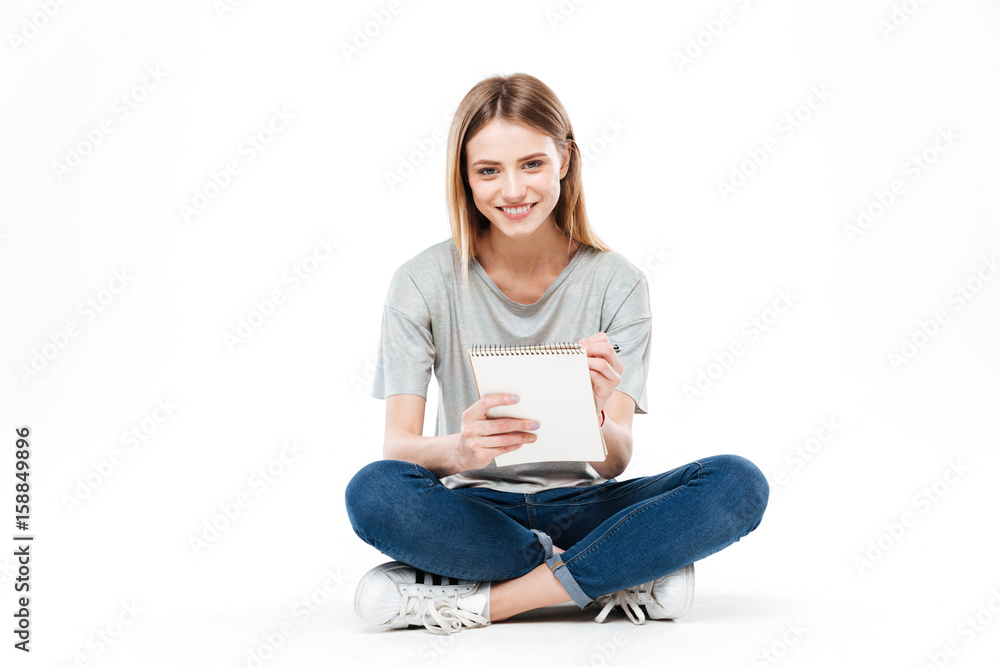 Young woman using pencil and notebook Young woman using pencil and notebook