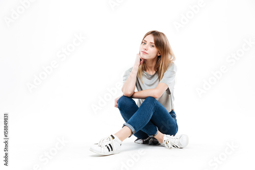Quadro su tela Thoughtful woman sitting cross-legged