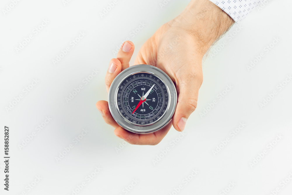 Businessman with a compass holding in hand Businessman with a compass holding in hand