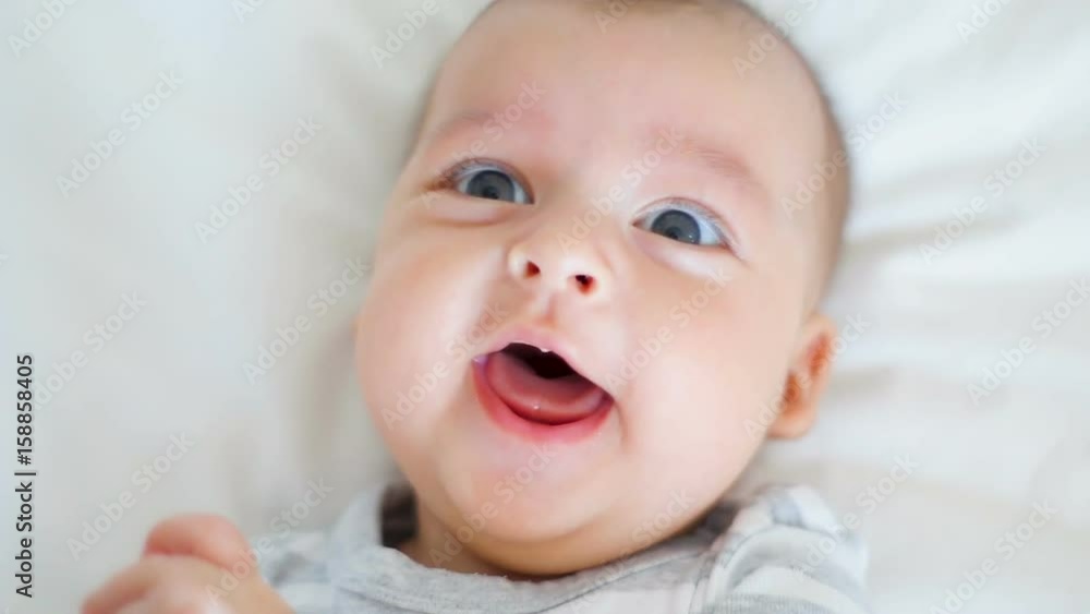 child is happy and laughing lying on bed at home child is happy and laughing lying on bed at home