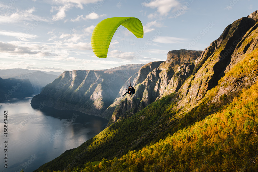 Paraglider silhouette flying over Aurlandfjord, Norway - obrazy, fototapety, plakaty 