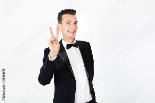 Young man master performing on the stage. Man in black suit on white background with copy space