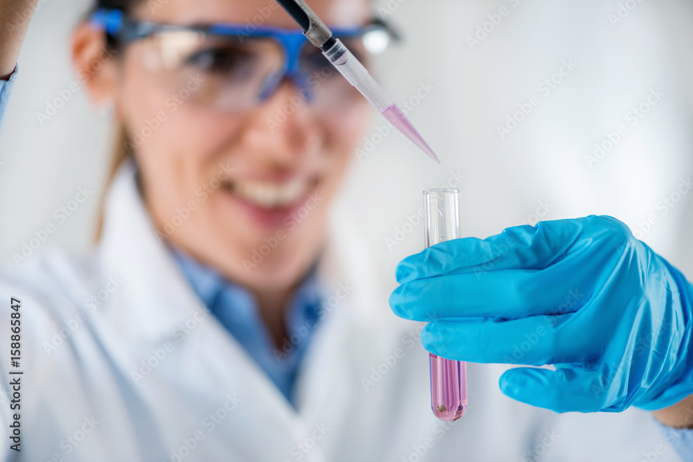 Laboratory technician with micro pipette Laboratory technician with micro pipette