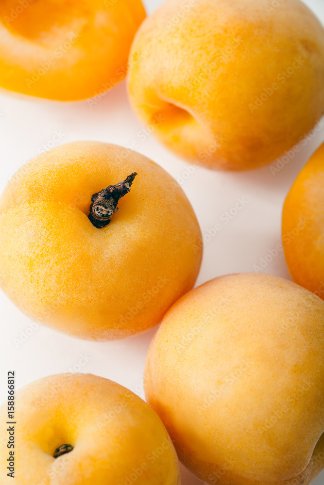 Fresh apricots whole and sliced on white background. Copy space Fresh apricots whole and sliced on white background. Copy space