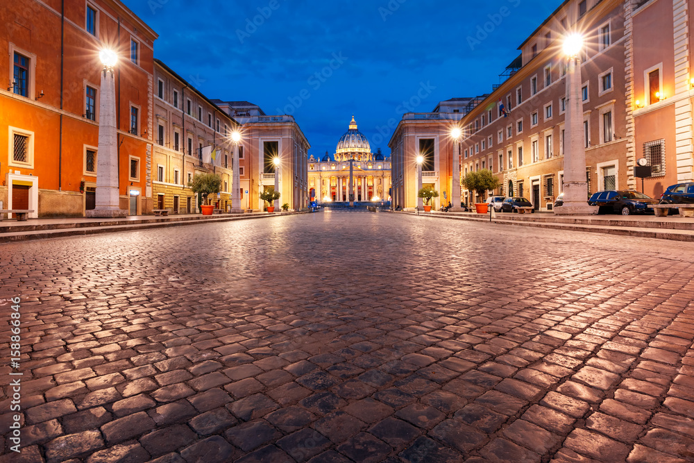 View of The Papal Basilica of St. Peter in the Vatican or Saint Peter Cathedral during morning blue hour in Rome, Italy.
