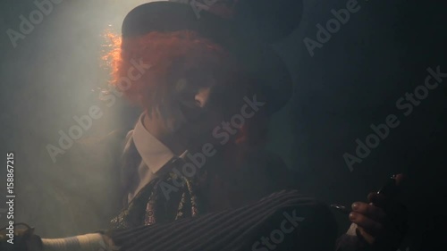 Mad hatter looks into the mirror and laughs