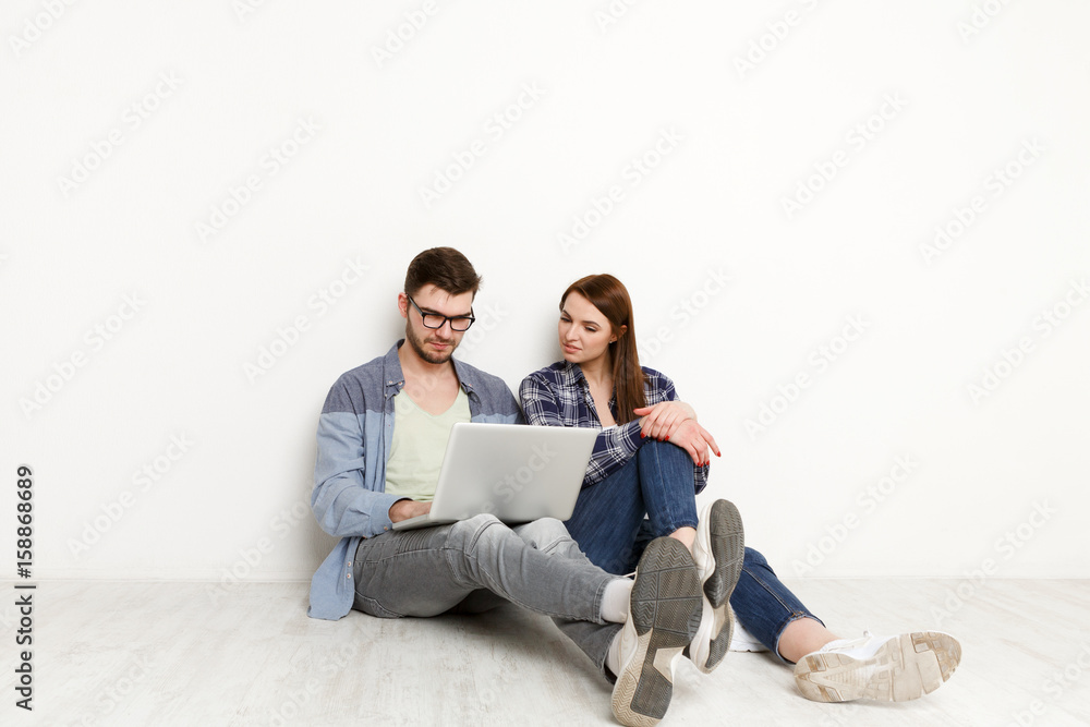 Couple choosing furniture online for new home Couple choosing furniture online for new home