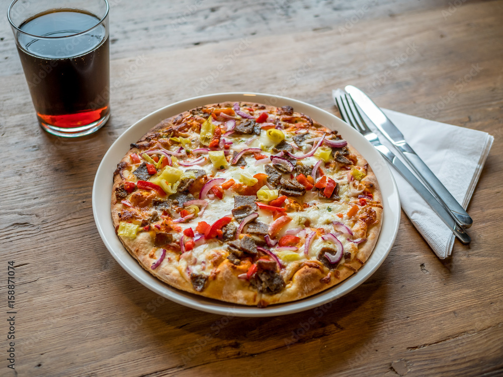 Delicious fresh pizza served on plate on wooden table Delicious fresh pizza served on plate on wooden table