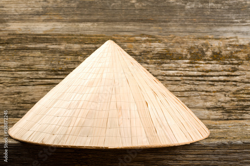 Asian hat on an old wooden background 