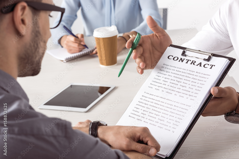 Fototapeta premium cropped shot of executive offering contract to businessman at meeting