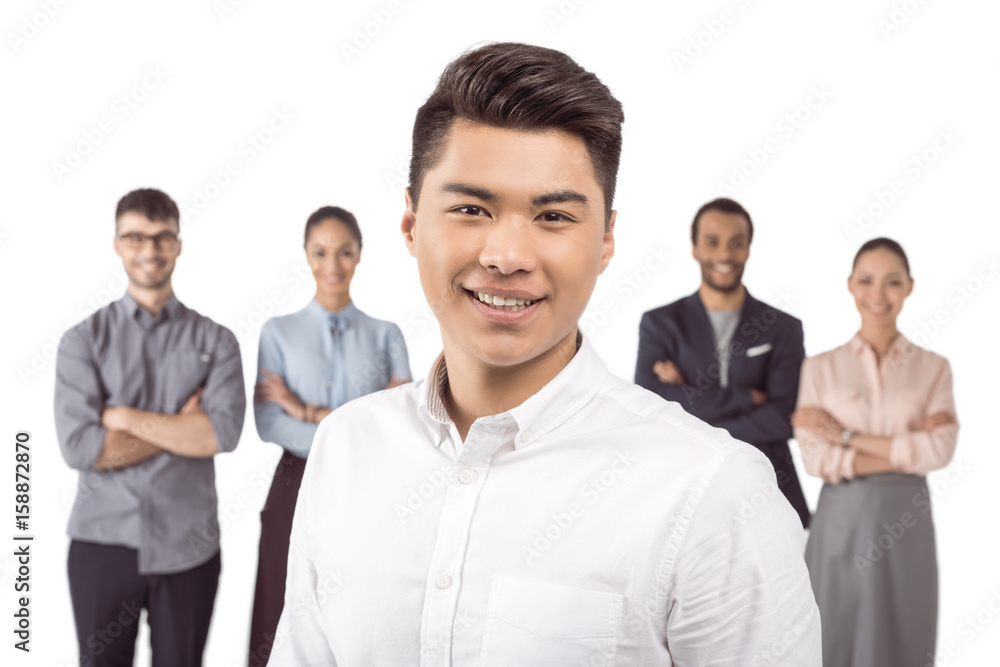portrait of asian businessman standing in front of his colleagues isolated on white portrait of asian businessman standing in front of his colleagues isolated on white