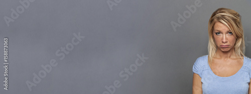 sad young blond woman looking disappointed, pouting for frustration, banner