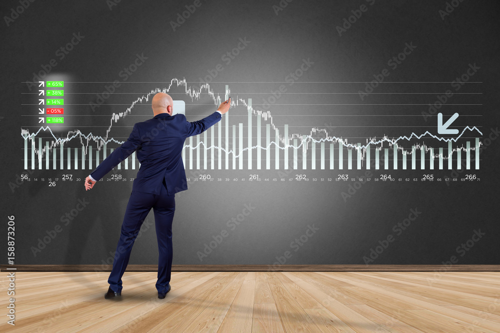 Man in front of a wall writing on a stock exchange interface - tradex concept Man in front of a wall writing on a stock exchange interface - tradex concept