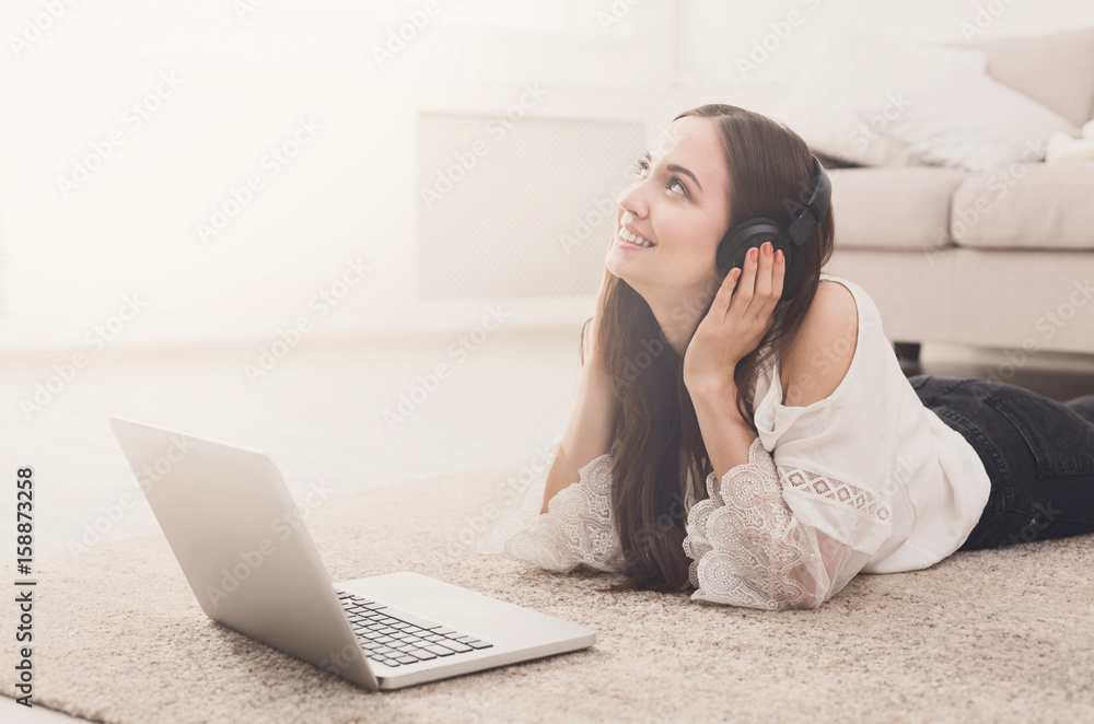Young girl in headphones. Online on laptop Young girl in headphones. Online on laptop