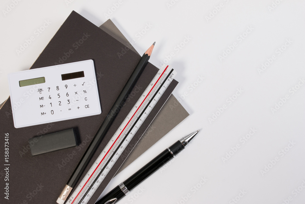 Top view. Modern business office desk table with modern business supplies book, pen ruler and calculator. Business office desk workplace with copy space. Top view. Modern business office desk table with modern business supplies book, pen ruler and calculator. Business office desk workplace with copy space.