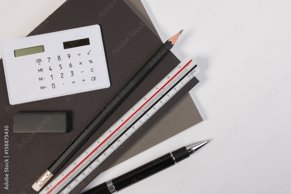 Top view. Modern business office desk table with modern business supplies book, pen ruler and calculator. Business office desk workplace with copy space. Top view. Modern business office desk table with modern business supplies book, pen ruler and calculator. Business office desk workplace with copy space.